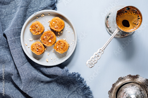 Bosnian and Turkish dessert called Ruzica served on a grey background with cup of coffee photo