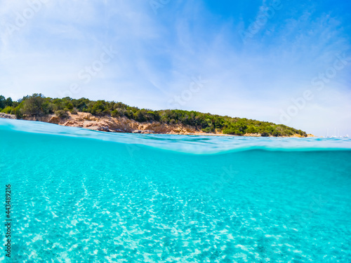  Selective focus  Stunning view of half underwater sea and half blue sky. La Maddalena Archipelago  Sardinia  Italy. Concept  split  fifty fifty  natural background with copy space.