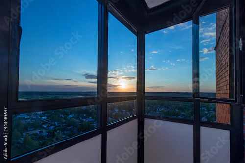 Sunset view from the balcony of a high-rise building on the outskirts of a megalopolis in Russia.