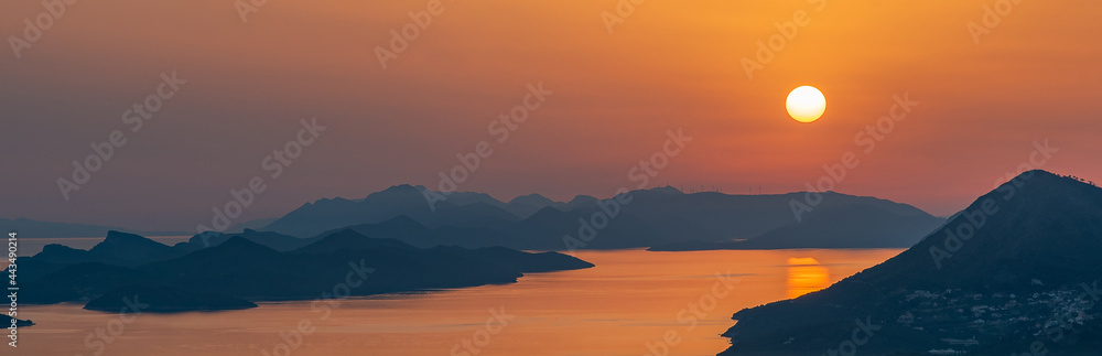 orange sunset. islands with mountain peaks. Adriatic sea. Dubrovnik, Croatia.