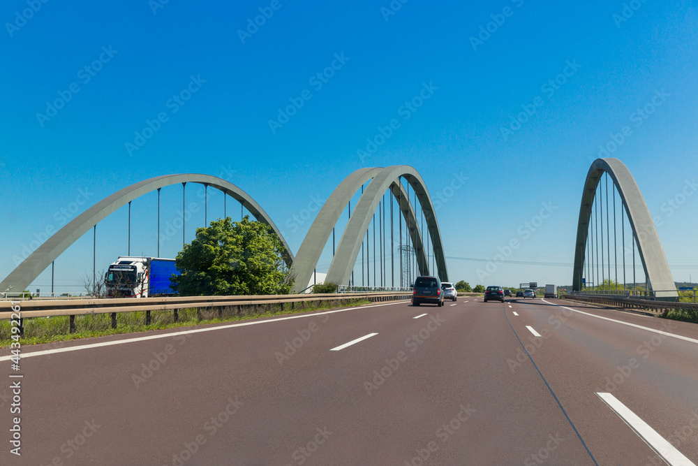 Fototapeta premium June 2, 2021 Germany, Bavaria. Cars drive over a bridge on an expressway in Germany