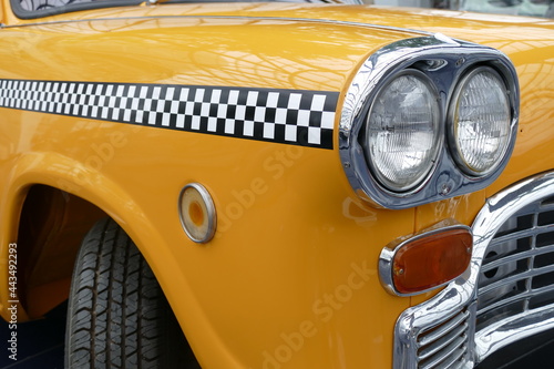 Details of the front of an old yellow cab of New York.