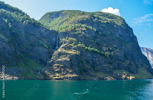 Beautiful scenery with mountain and waterfall in a stunning setting along the Sognefjord between the villages of Flam and Gudvangen in Norway