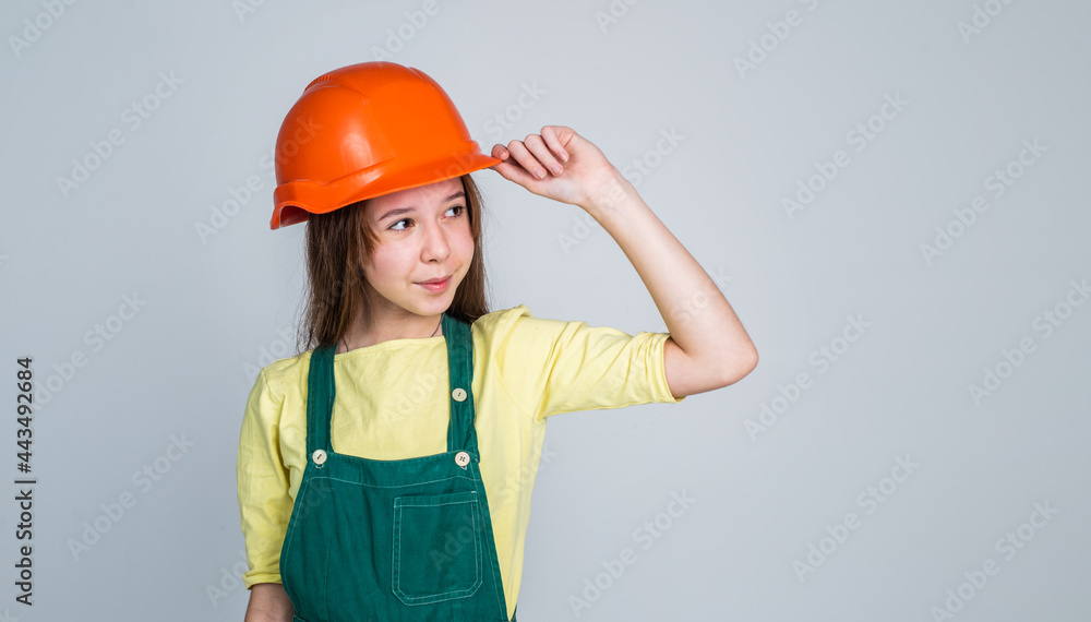 teen girl in uniform and helmet. female builder in hard hat. building and construction