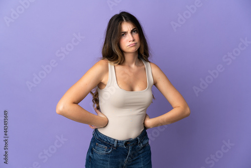 Young caucasian woman isolated on purple background angry © luismolinero