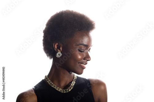Close up portrait of smiling black african american woman with afro hairstyle on white studio background.