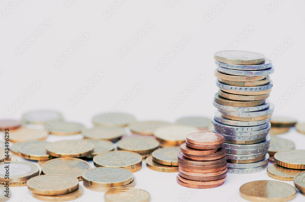 Euro coins stacked against white background with copy space Euro coins stacked against white background with copy space
