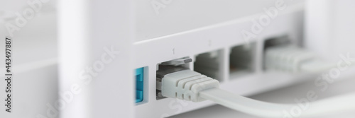 Network cable is plugged into socket of access point closeup photo