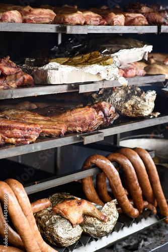 A large grill is used to cook different types of meat and vegetables. Street Food Festival.