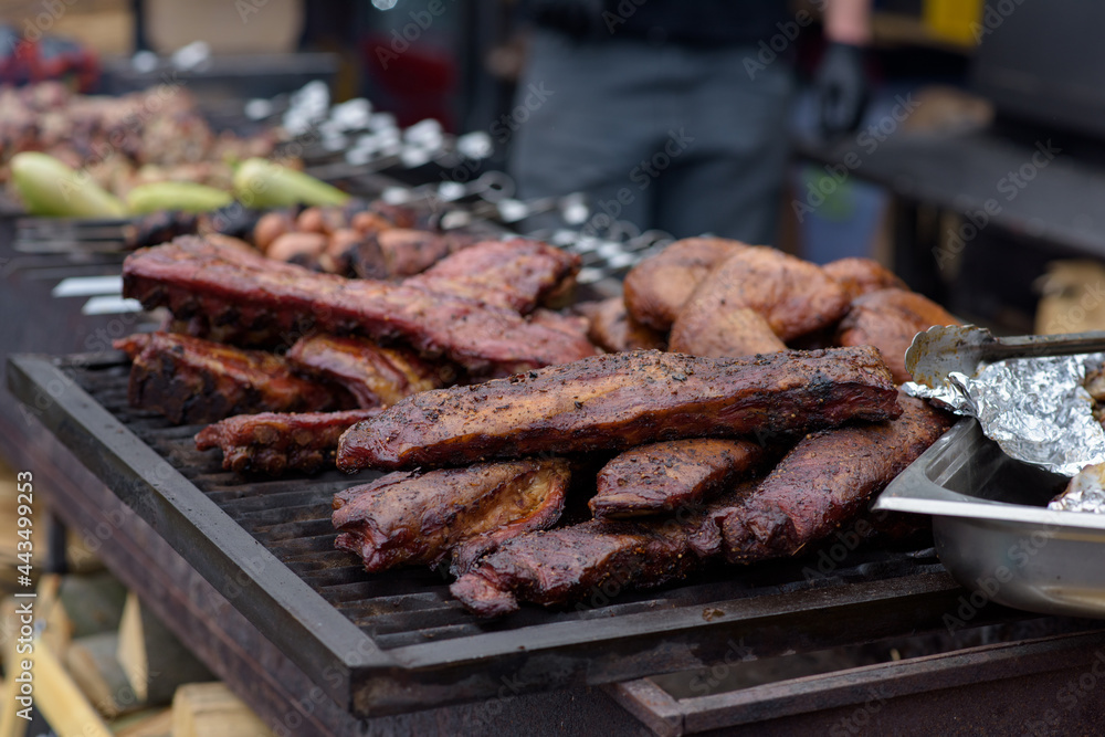 Grilled pork baby ribs with barbecue sauce on the grill. Festival street food