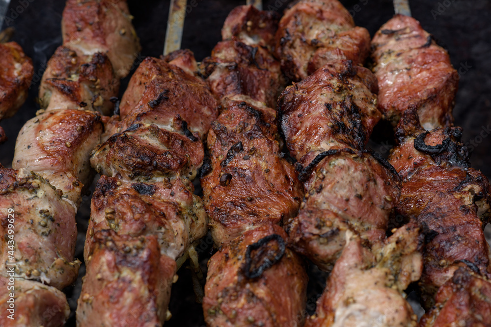 Grilled skewers of meat on the coals, with smoke. street food.