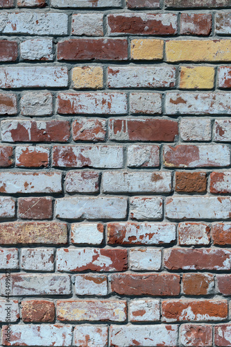 old brick wall of bricks of different colours as the background