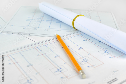 Printed electrical diagram, blurred background. Workplace of an electrician designer. Engineer's drawing on a white background.