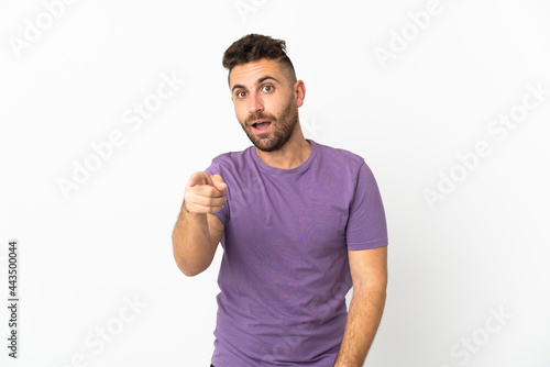 Caucasian man isolated on white background surprised and pointing front
