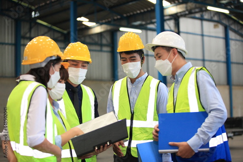 Team workers wear protective face masks for safety industrial factory. worker meeting before start working in factory or warehouse