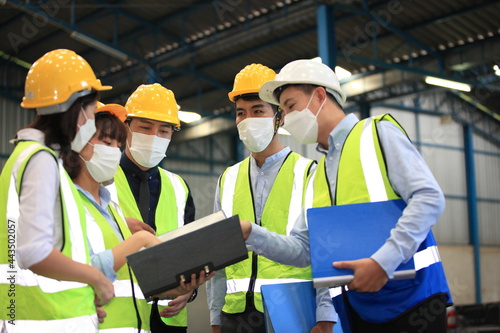 Team workers wear protective face masks for safety industrial factory. worker meeting before start working in factory or warehouse