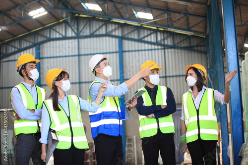 Team workers wear protective face masks for safety industrial factory. worker meeting before start working in factory or warehouse