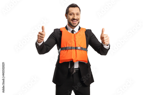 Businessman wearing an orange life vest and gesturing a thumb up sign
