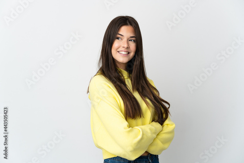 Teenager Brazilian girl isolated on white background with arms crossed and happy © luismolinero