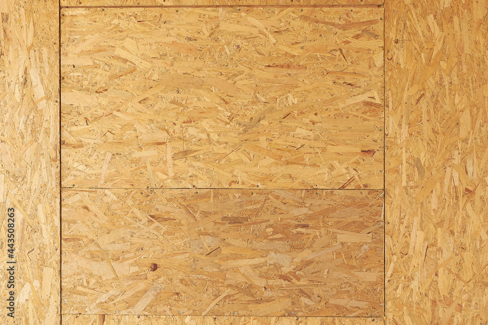 Fototapeta premium OSB boards are made of brown wood chips sanded into a wooden background. Top view of OSB wood veneer background, tight, seamless surfaces.