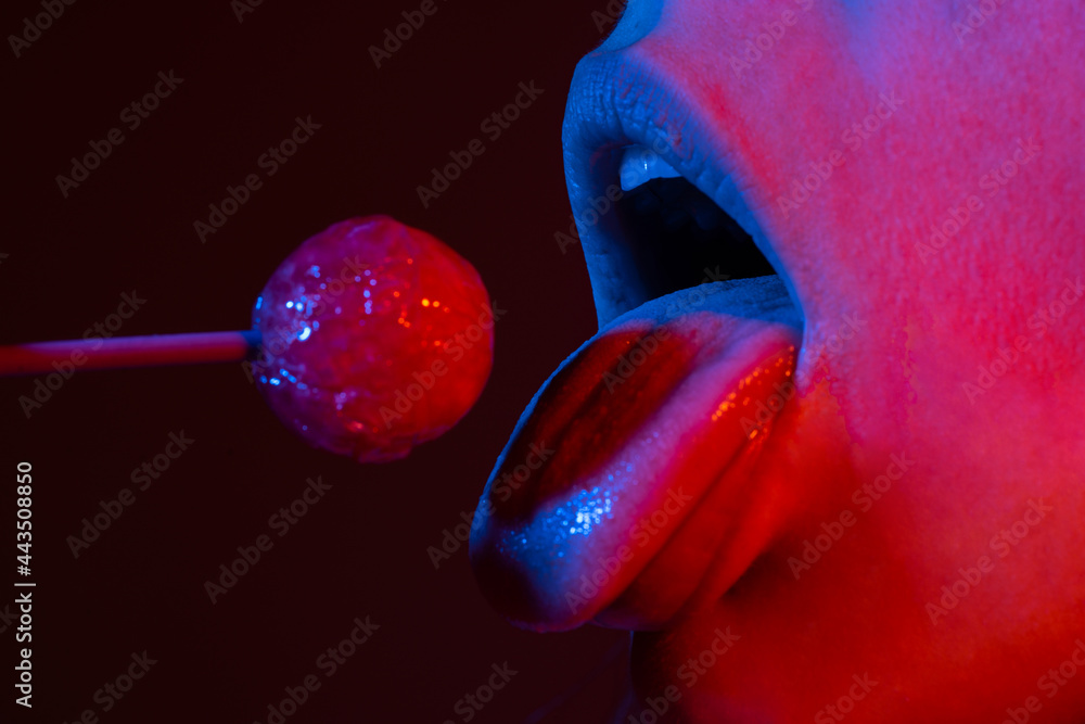 Close up lips with lollipop isolated, sexy blowjob, sensual mouth with lipstick eats sweets. Sexy design for women and girls. Beauty lips on neon lights. Night club background. Close up lips with lollipop isolated, sexy blowjob, sensual mouth with lipstick eats sweets. Sexy design for women and girls. Beauty lips on neon lights. Night club background.