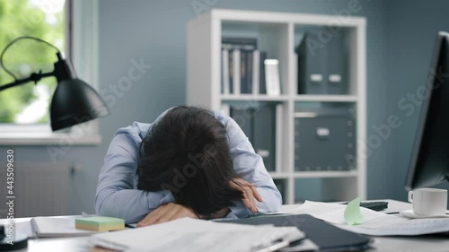 Overworked woman sitting at office photo