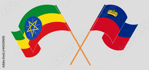 Crossed and waving flags of Ethiopia and Liechtenstein