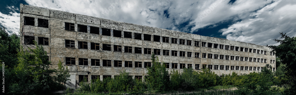 destroyed abandoned large concrete building on a summer day destroyed abandoned large concrete building on a summer day