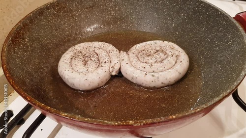 German style spiral fried sausages for beer. Fried in a pan in vegetable oil