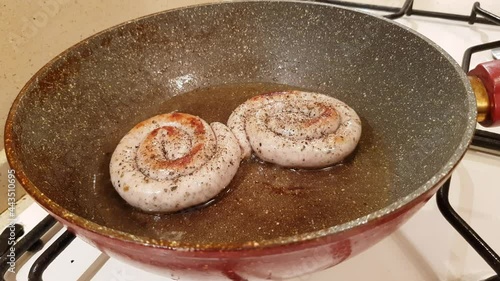 German style spiral fried sausages for beer. Fried in a pan in vegetable oil