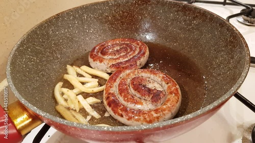 German style spiral fried sausages for beer. Fried in a pan in vegetable oil