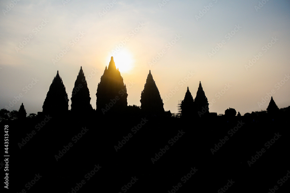Silhouette of the ancient Prambanan temple complex during sunset in Yogyakarta, Indonesia. Blue and orange sky. For background. No people.