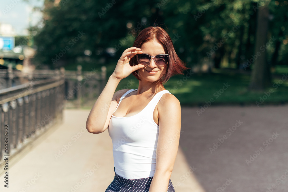 Girl kakazets with a bob hairstyle in sunglasses in the park