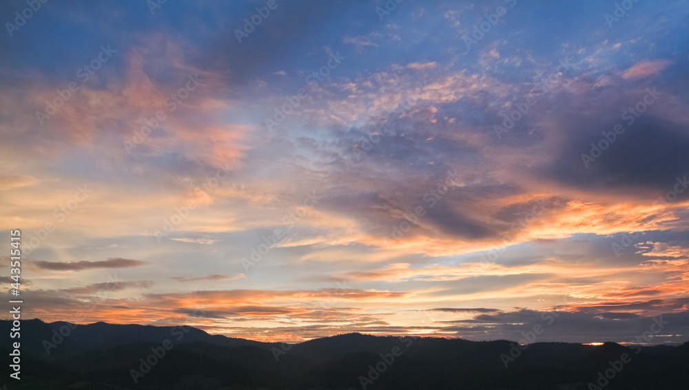 Colorful Sunset sky in mountains with clouds, Horizon. Warm Colours.