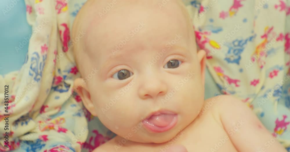 cute little baby enjoying sitting in the children's bath on the bright sheet.portrait of modern happy child close up. cute little baby enjoying sitting in the children's bath on the bright sheet.portrait of modern happy child close up.