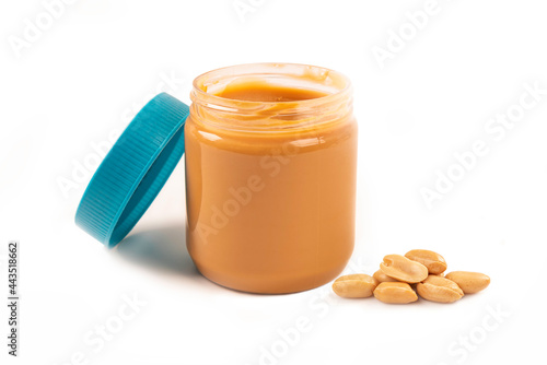 Peanut butter in jar on white background.