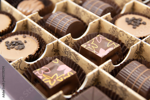Chocolate candies set in an open box. Chocolate candy closeup. Assorted chocolate sweets.  © Renata.Ka