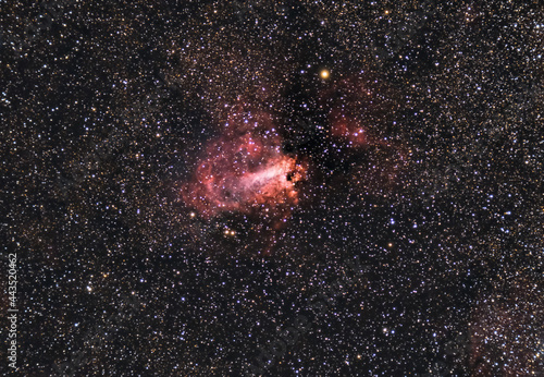 The Omega Nebula, also known as the Swan Nebula, Checkmark Nebula, and Horseshoe Nebula Messier 17, M17, captured with a refracting telescope and a cooled astronomical camera