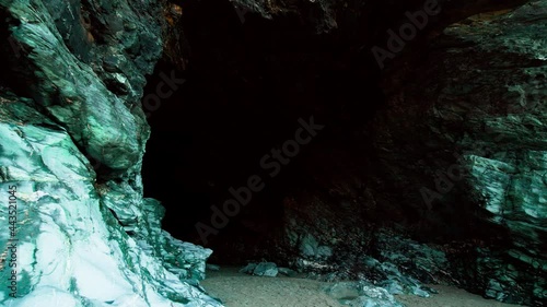 Entering into a dark terrifying cave in Tintagel Castle, Cornwall, England in 4K. Big Rock formation cave in Britain.