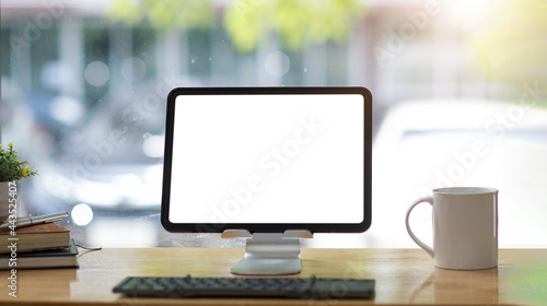 Blank screen Laptop computer and poster workspace background in modern office © wichayada
