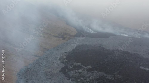 Dramatic scenery at rugged black rock surface of volcano eruption, aerial photo