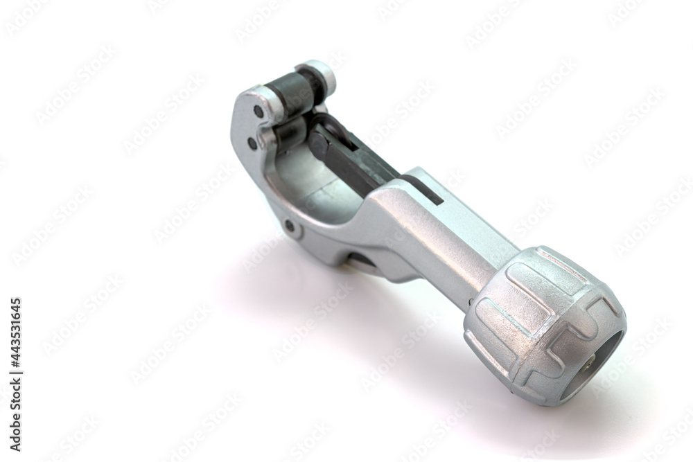 Metal pipe cutter for copper and aluminum isolated on white background. Selective focus. Metal pipe cutter for copper and aluminum isolated on white background. Selective focus.
