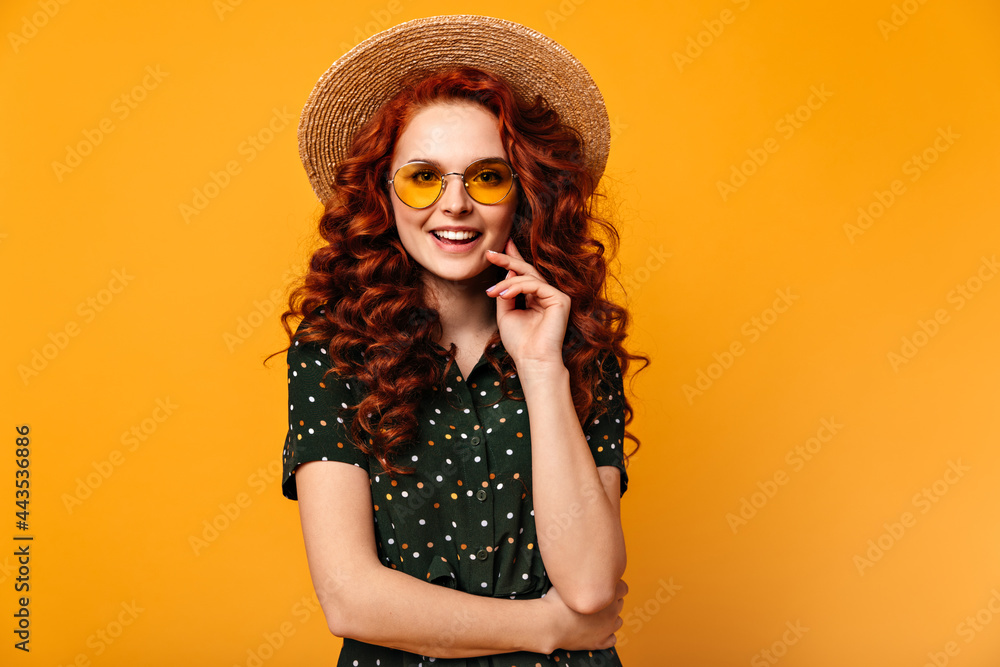 Front view of winsome ginger woman. Attractive caucasian girl smiling on yellow background. Front view of winsome ginger woman. Attractive caucasian girl smiling on yellow background.