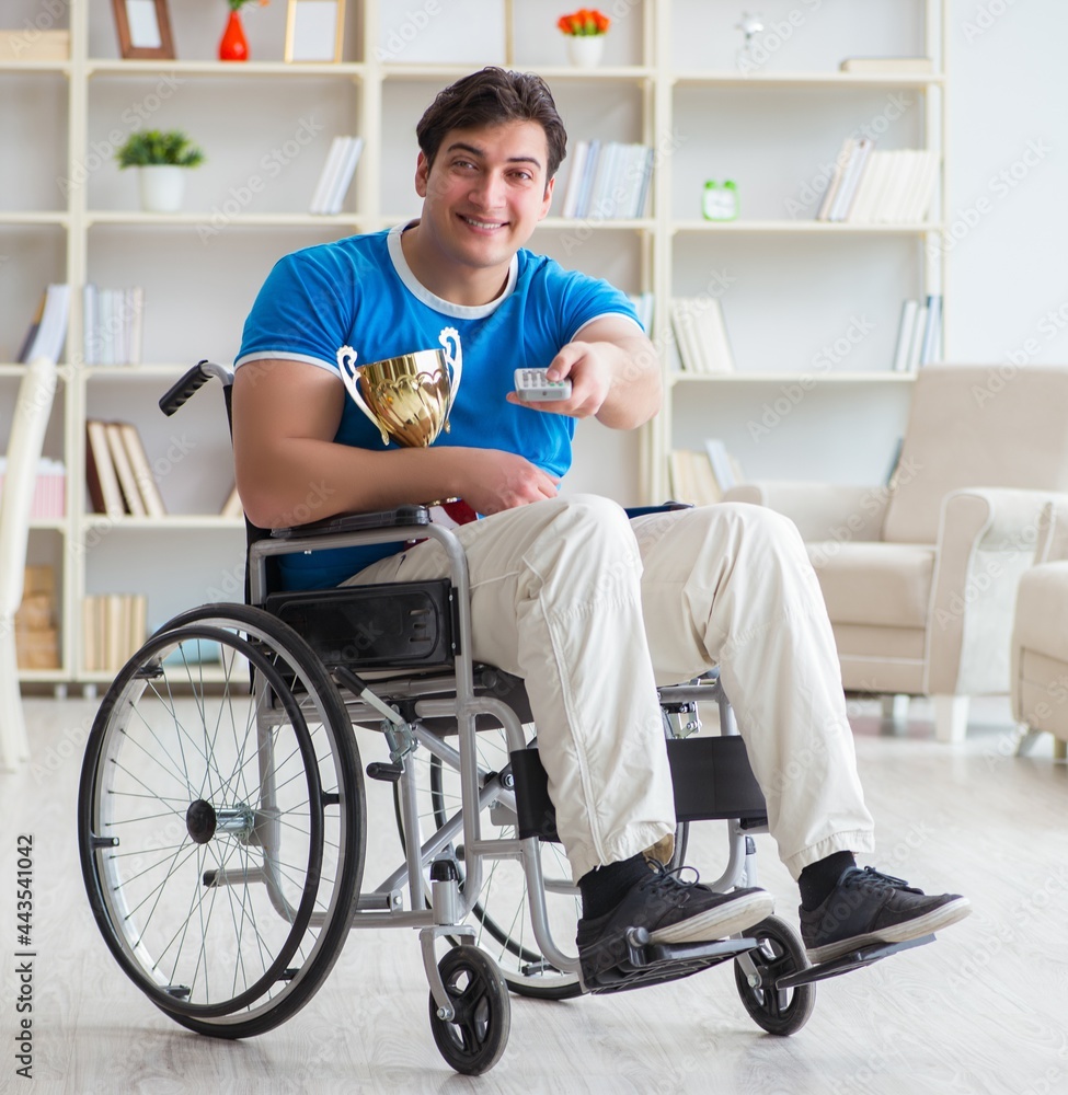 Disabled man watching sports on tv Disabled man watching sports on tv