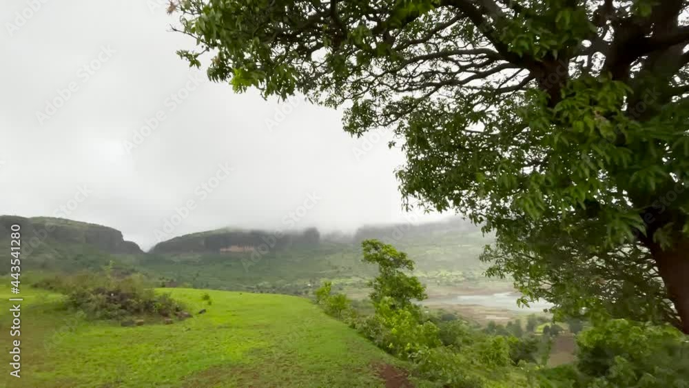 Meadow Hills Overlooking Brahmagiri Ridges Against Overcast Sky At Trimbakeshwar In Western Ghats, Maharashtra, India. - Aerial Shot Meadow Hills Overlooking Brahmagiri Ridges Against Overcast Sky At Trimbakeshwar In Western Ghats, Maharashtra, India. - Aerial Shot