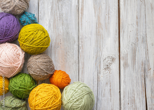 Fotografija colorful yarn balls on white wood table