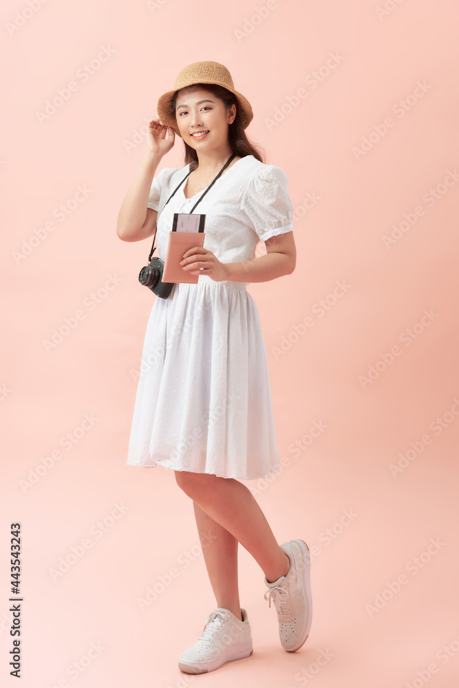 Smiling woman traveler holding smartphone passport in holiday on pink backgrounds, relaxation concept, travel concept Smiling woman traveler holding smartphone passport in holiday on pink backgrounds, relaxation concept, travel concept