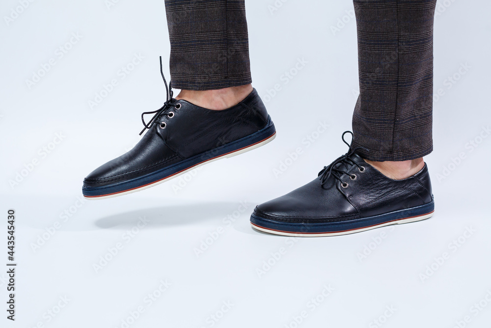 A man is wearing classic black shoes made of natural leather on lace, shoes for men under business style