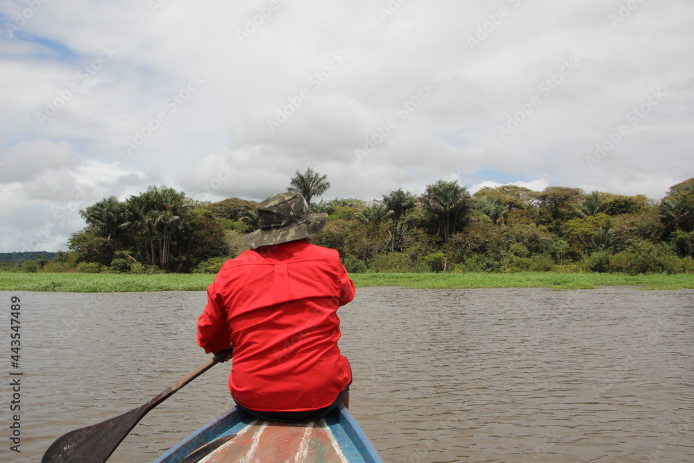 Paddling in a dugout canoe in the Tapajos National Park near Santarem, Brazil. Paddling in a dugout canoe in the Tapajos National Park near Santarem, Brazil.