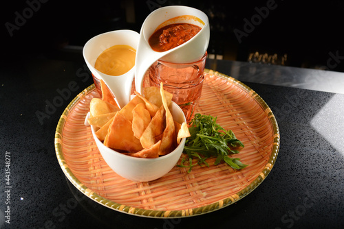 Canvas Print premium golden crispy chips with cheese and spicy tomato salsa sauce dip on bask